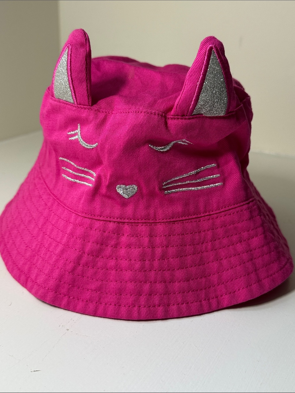 Kids pink cotton blend kitty bucket hat with cat ears.